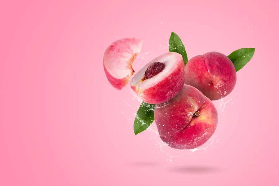 Free Premium Stock Photos Creative layout made from whole and slice of Ripe juicy peaches fruit and water Splashing on a pink background