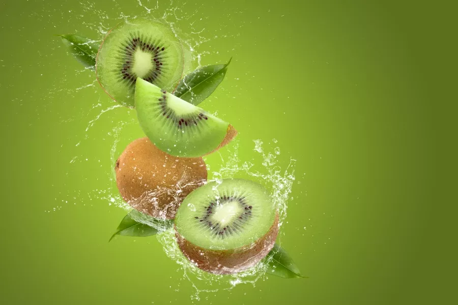 Free Premium Stock Photos Creative layout made from Sliced of kiwi and water Splashing on a green background