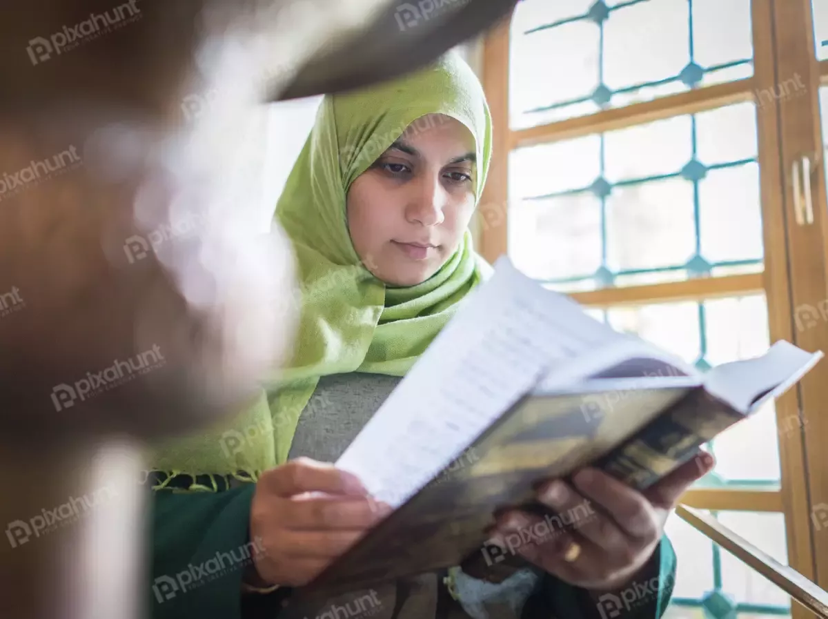 Free Premium Stock Photos Woman reading Quran very carefully | A MUSLIM WOMAN READING IN QURAN KORAN