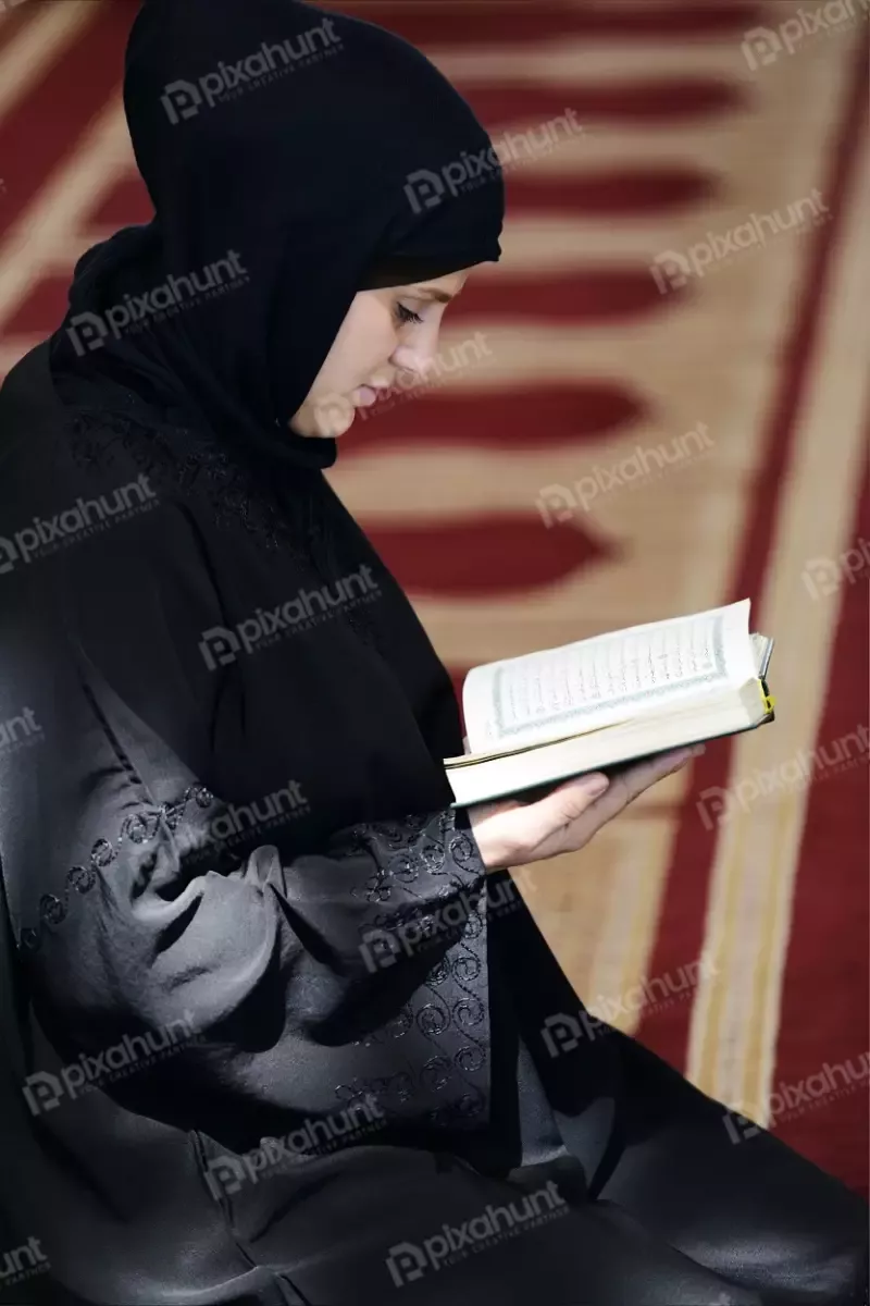 Free Premium Stock Photos Muslim Arabic Woman Sitting And Reading Holy Koran very carefully